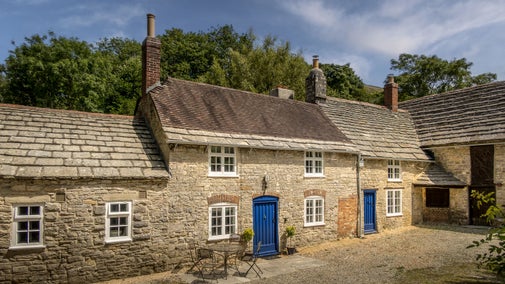The front of Boar Mill Cottage, a stone holiday cottage that was once a bakery, Dorset